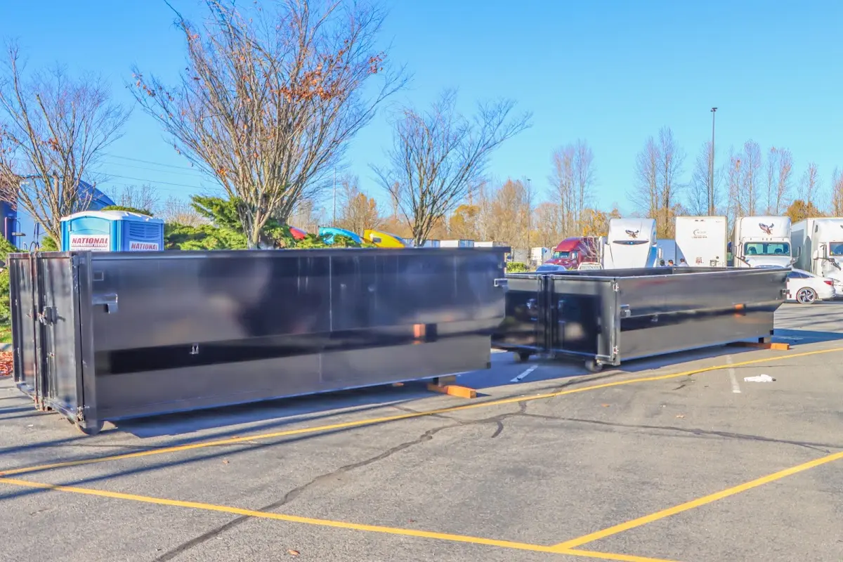Professional dumpster rental service with roll-off container on residential driveway in Quartz Hill